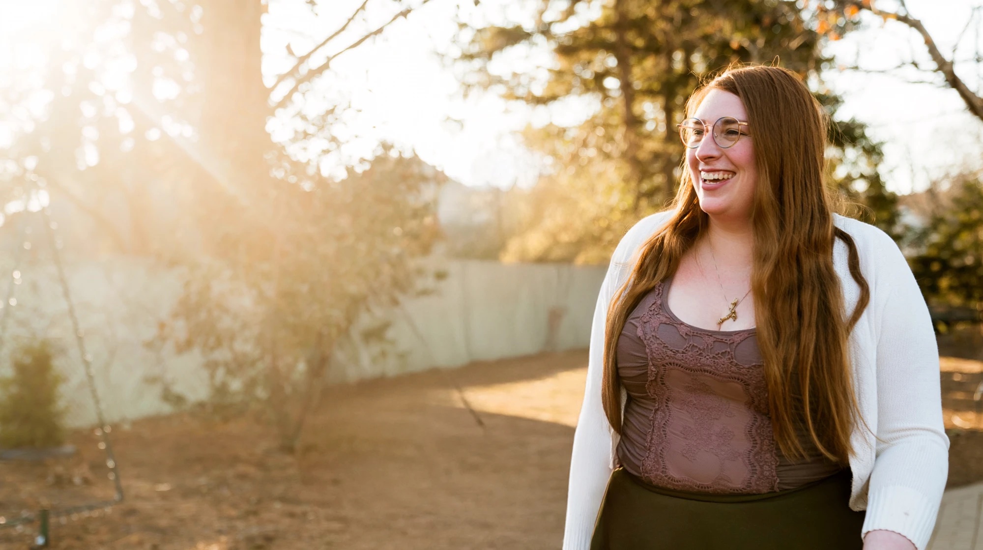 Charlotte Wolf laughing outdoors in the late-afternoon sun